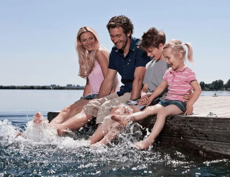 Family enjoying time by the lake dock.